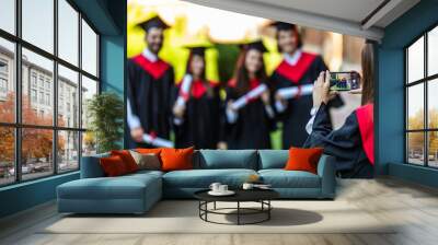 Group of students taking a picture in their graduation at University ceremony Wall mural